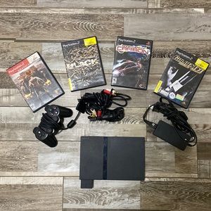 Play Station 2 Console, controller, plug ins, and four games.